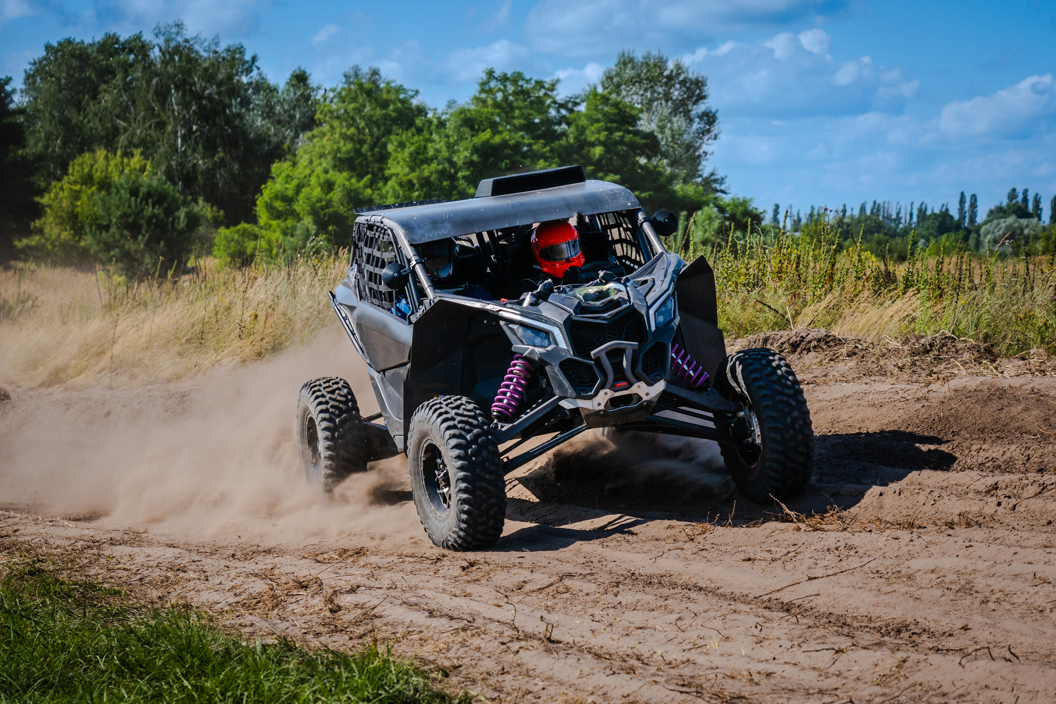 ATV and UTV riding in sandy dusty track. Amateur competitions. 4x4. UTV offroad vehicle driving in sand dunes.