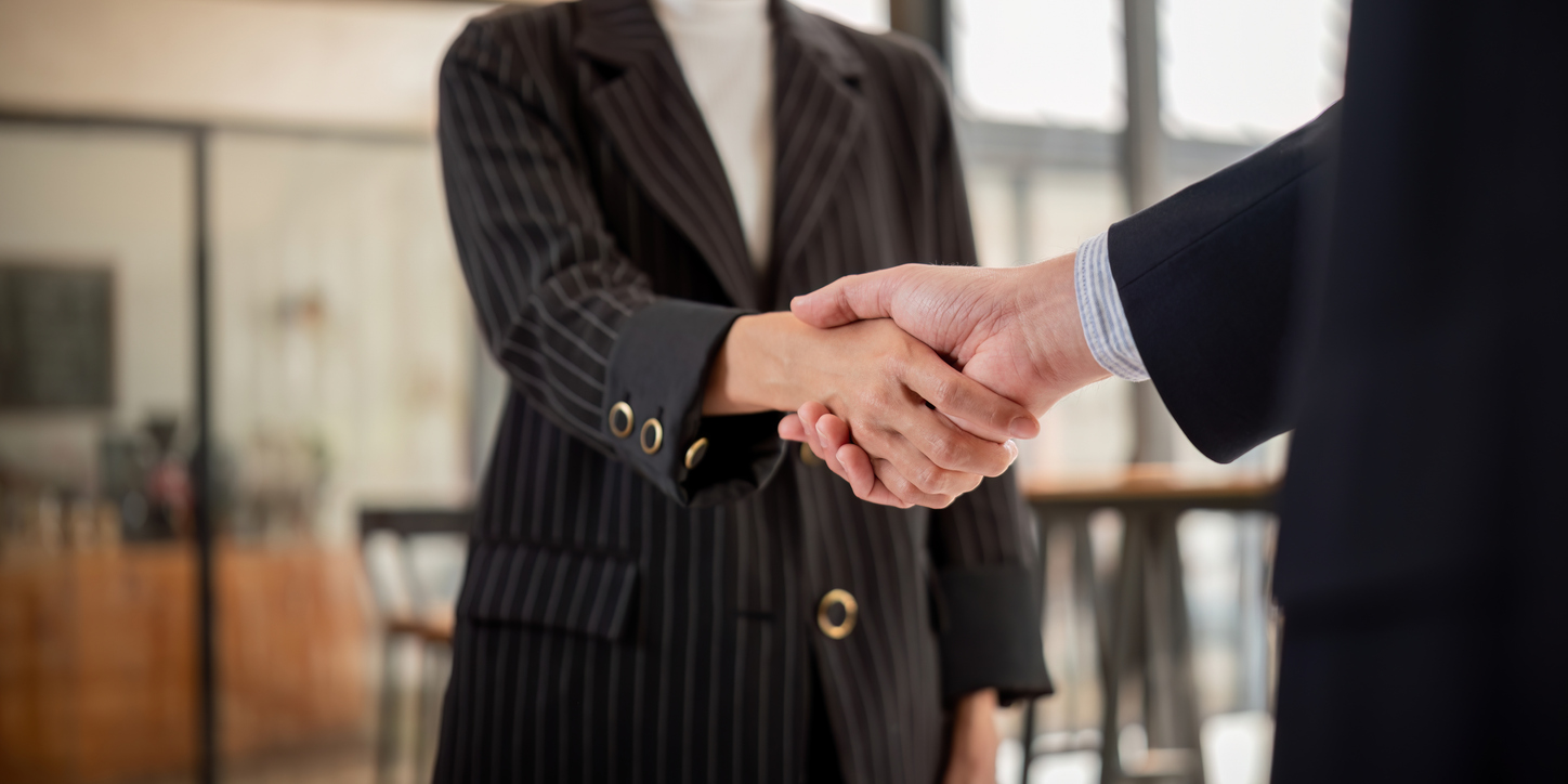 Handshake between two business professionals after a contract agreement, symbolizing partnership, collaboration, and successful teamwork.