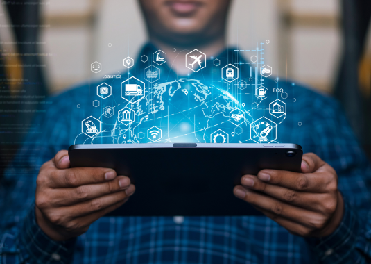 Team gathered around a laptop, discussing analytics and reviewing dashboard data, with charts and graphs visible, illustrating collaborative data analysis and business insights.